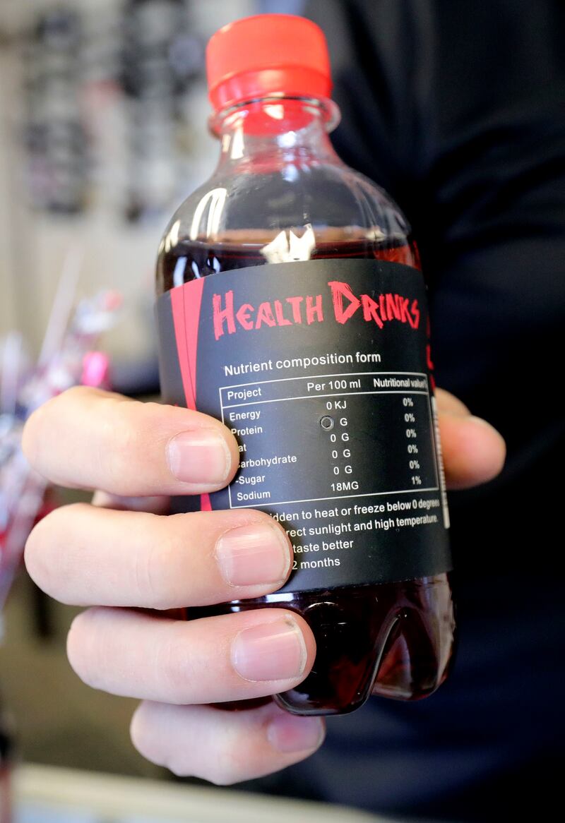 Thal Dixon holds a spy camera, hidden in a soda bottle, at Dixon Security Cameras in South Salt Lake on Tuesday, March 12, 2019. The camera is in the nutritional information label.