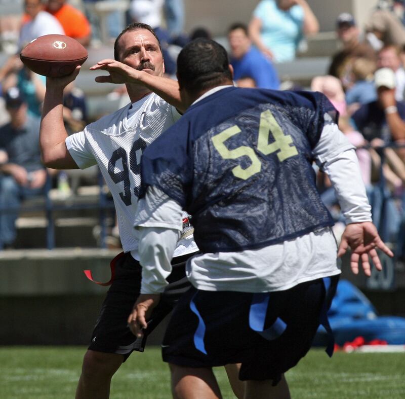 Jason Buck throws the ball on the flea-flicker under pressure from Peter Tuipulotu as the two join other former Cougars in the Legends game before the annual spring scrimmage for the BYU football team at Lavell Edwards on April 14, 2007.