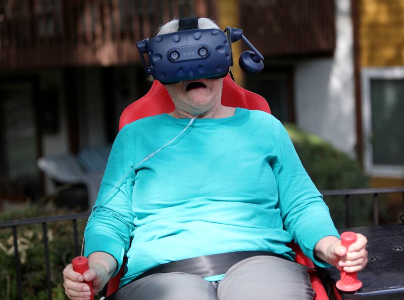Gloria Bird, 70, reacts to “Montezuma's Treasure Ride,” an Innovative Entertainment virtual reality motion ride, at Cove Point Retirement Community in Provo on Wednesday, Aug. 22, 2018.