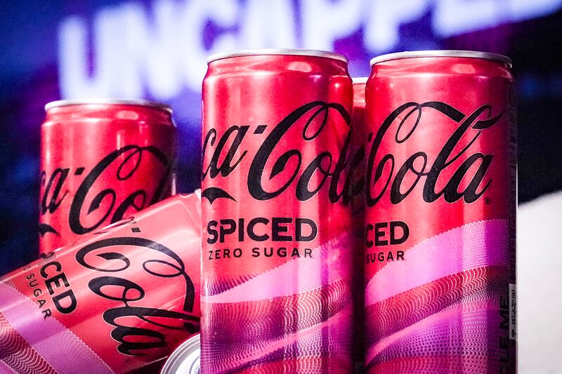 Photo shows four cans of Coca-Cola Spiced.