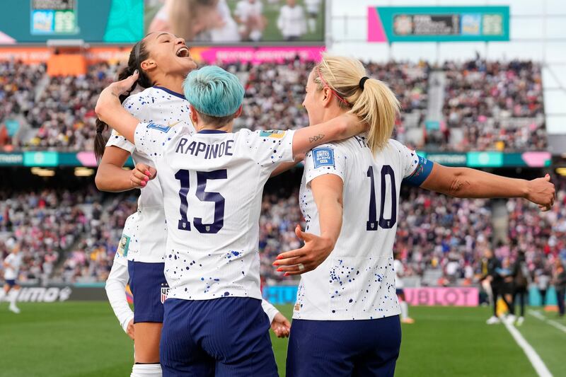 United States’ Lindsey Horan, right, celebrates with Sophia Smith, left, and Megan Rapinoe after scoring during the Women’s World Cup soccer match between the United States and Vietnam at Eden Park in Auckland, New Zealand, Saturday, July 22, 2023. (AP Photo/Abbie Parr)