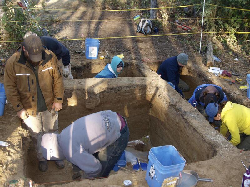This handout photo, taken in Aug. 2010, provided by the journal Science shows excavating at the site in Alaska. Some 11,500 years ago one of America's earliest families laid the remains of a three-year-old child to rest in their home in what is now Alaska