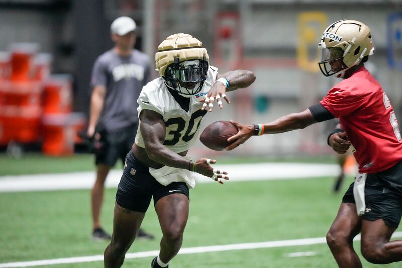 New Orleans Saints running back Jamaal Williams (30) runs through drills at the NFL team’s football training camp in Metairie, La., Friday, Aug. 4, 2023.