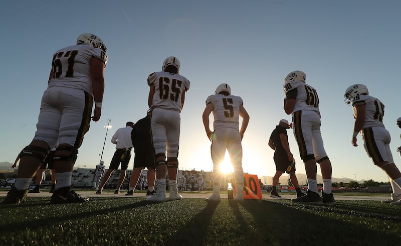 Davis football players watch the game from the sidelines as they play Herriman in Herriman on Thursday, Aug. 13, 2020.