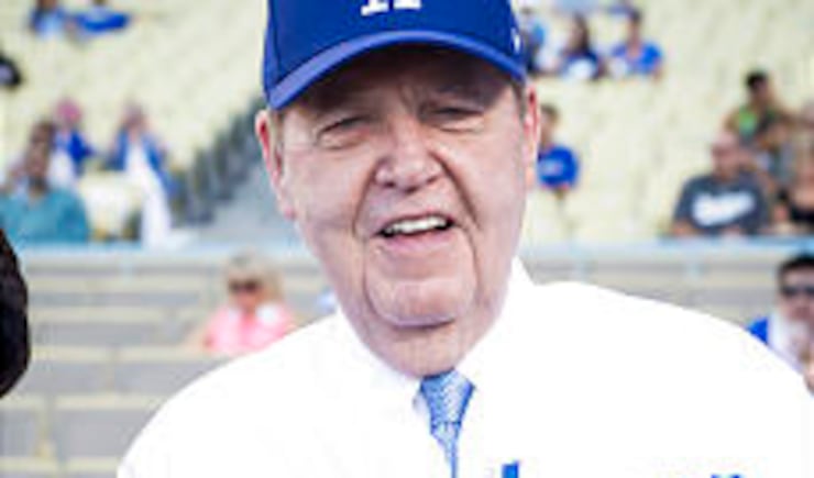 Elder Jeffrey R. Holland throws out the ceremonial first pitch as his wife, Patricia, looks on at Dodger Stadium in Los Angeles, California, on June 28, 2013.