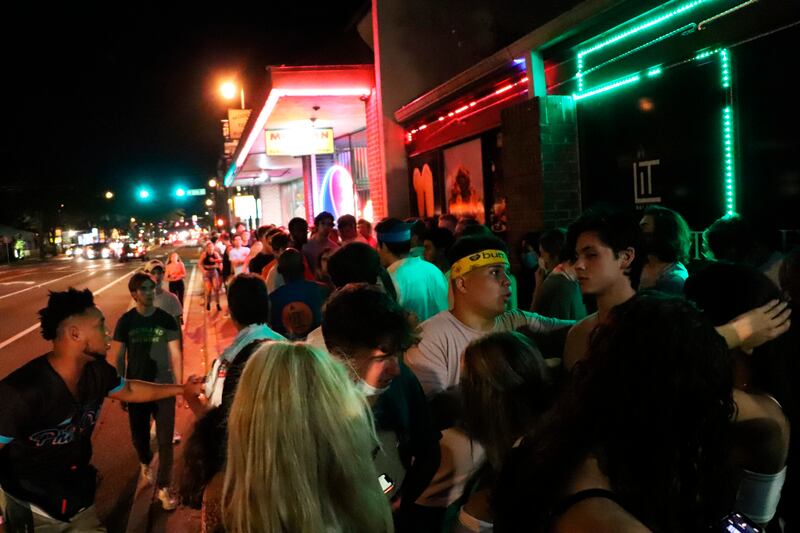 In this photo provided by Fresh Take Florida, people wait in line outside a bar following a University of Florida football game, Saturday, Sept. 16, 2020, in Gainesville, Fla