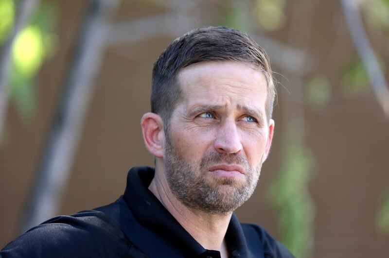 Brian Redd, Utah Department of Corrections executive director, works in the field as Adult Parole and Probation agents take a probation fugitive into custody in South Salt Lake on Thursday.