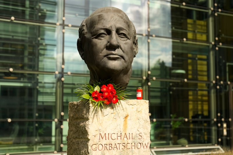 Flowers and a candle are placed at a bust of the former Soviet President Mikhail Gorbachev in Berlin on Aug. 31, 2022. 