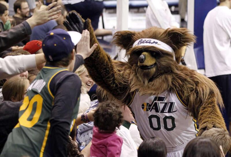 The Utah Jazz Bear gives high fives to fans during the Jazz open exhibition game at the Energy Solutions Arena in Salt Lake City Saturday, Dec. 17, 2011.\r\n