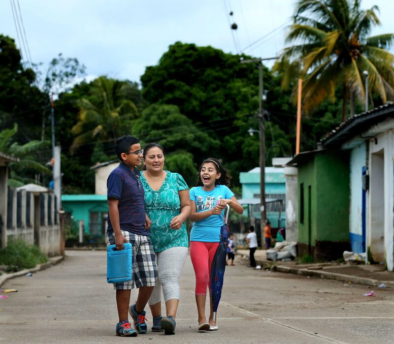 Patrick, his mother Maria Santiago, and his sister Sarai walk home in Jerez, Guatemala, on Monday, Oct. 15, 2018.