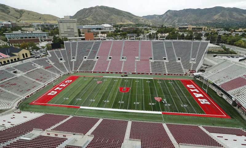 Workers finish work on the new turf field in Rice Eccles Stadium in Salt Lake City Wednesday, Sept. 30, 2015.