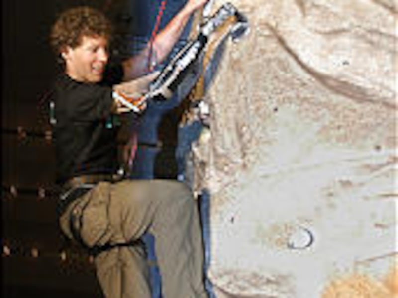 Aron Ralston, the climber who cut off his arm to survive a harrowing ordeal in a Utah canyon in 2003, scales an indoor climbing wall in Reno with the aid of a specially designed artificial arm.