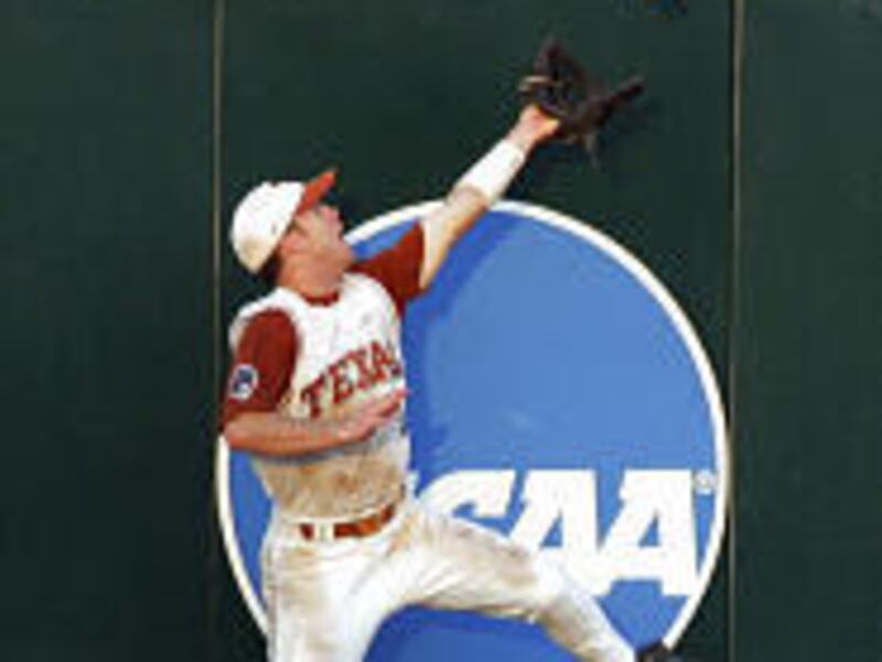 Texas' Nick Peoples leaps as he catches a ball hit by Tulane's Micah Owings in Monday's game.