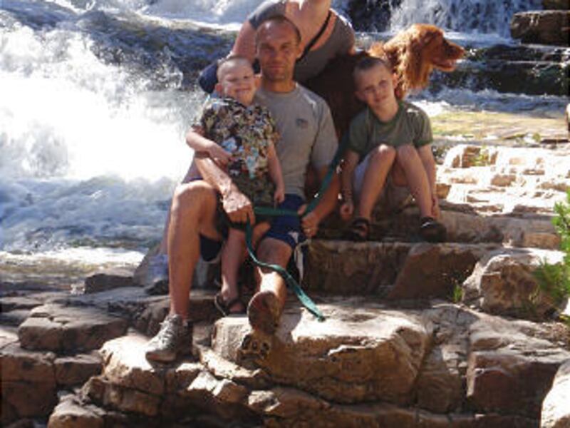 Sandra and Ian Cameron and their boys, Connor (in Ian's arms) and Clayton, as well as Sadie the Irish lab.