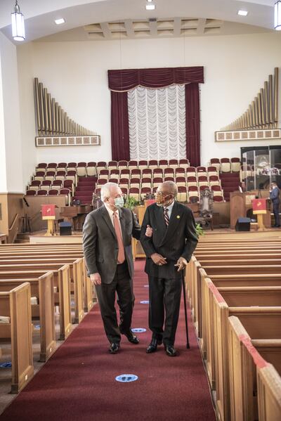 Elder Jack N. Gerard walks arm in arm with the Rev. Amos C. Brown in the sanctuary of the Third Baptist Church of San Francisco.