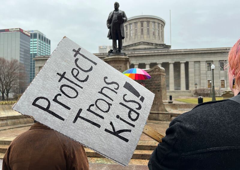 Protesters advocating for transgender rights and health care stand outside of the Ohio Statehouse on Jan. 24, 2024, in Columbus, Ohio.