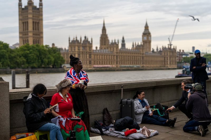 Queen supporters wait to be first in line bidding farewell to Queen Elizabeth II in London, Tuesday, Sept. 13, 2022.