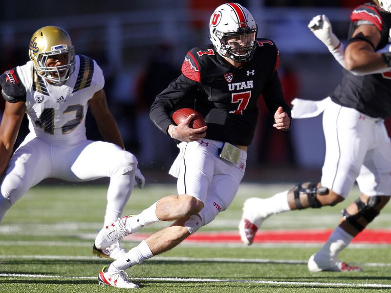 Utah quarterback Travis Wilson looks for yardage during game against the UCLA Bruins at Rice-Eccles Stadium in Salt Lake City, Saturday, Nov. 21, 2015.