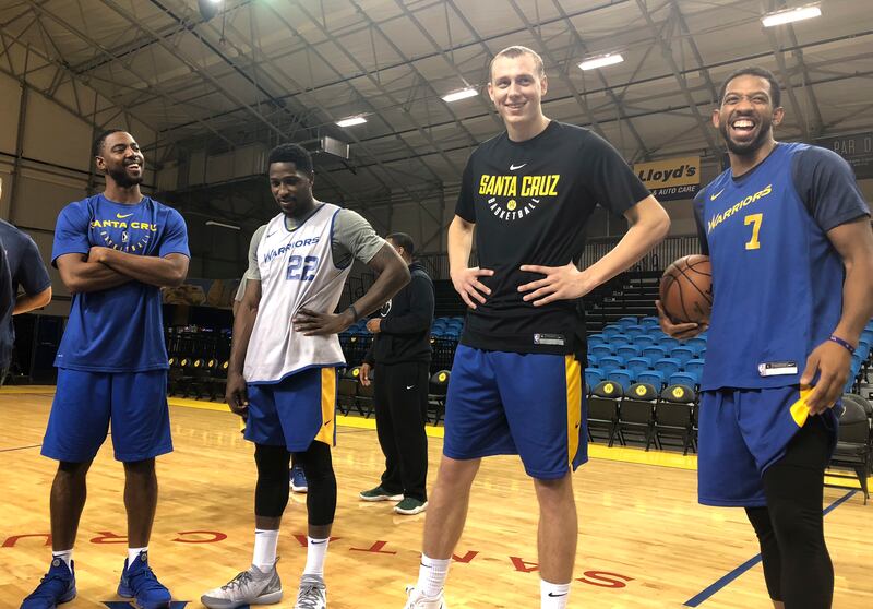 In this Dec. 4, 2018 photo, from left, Santa Cruz Warriors coach Aaron Miles, guard Will Cherry, Alen Smailagic and Darius Morris talk after their basketball practice in Santa Cruz, Calif.