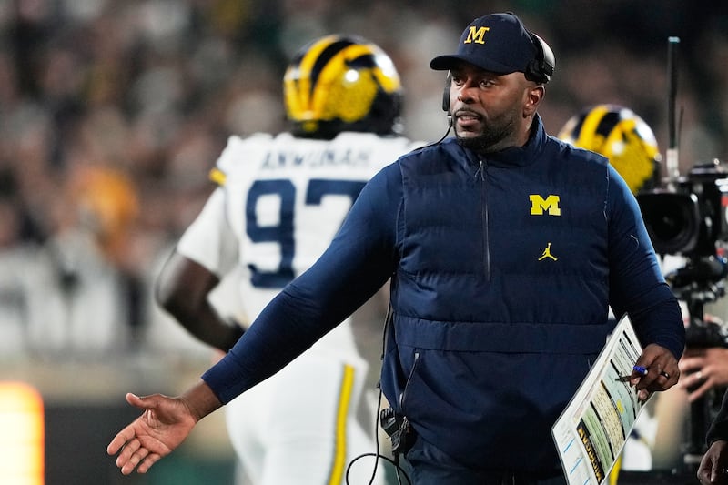 Michigan head coach Sherrone Moore walks on the sideline during the first half of an NCAA college football game against Michigan State Saturday, Oct. 25, 2025, in East Lansing, Mich.