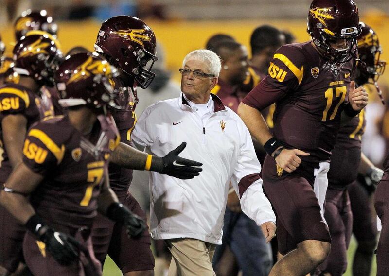 Arizona State head coach Dennis Erickson, center, heads to the locker room with his players before an NCAA college football game against California Friday, Nov. 25, 2011, in Temp, Ariz.