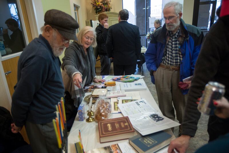 Sue Prottas, originally of Vancouver, Canada, and now living in Salt Lake City, displays Jewish religious materials to Doug Stark of Holladay, on right, while standing next to her husband Bob Prottas, originally of Seattle, Washington, and now living in S