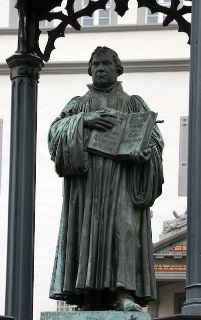 A bronze sculpture of Martin Luther holding the New Testament is seen on the market square in Wittenberg, eastern Germany, Tuesday, Oct. 31, 2006. German priest and church reformer Martin Luther on Oct. 31, 1517 pinned his controversial 95 theses on the d