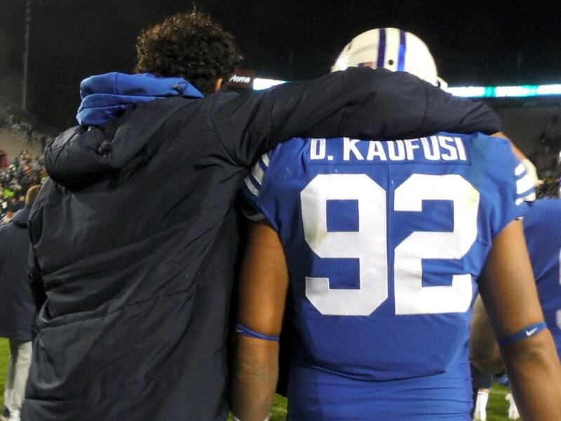 BYU defensive end Corbin Kaufusi, left, puts him arm around his brother, Devin Kaufusi, following the Cougars’ 45-10 win over New Mexico State on Saturday, Nov. 17, 2018 at LaVell Edwards Stadium in the team’s home finale.