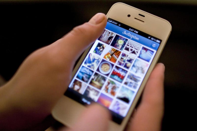 Instagram is demonstrated on an iPhone Monday, April 9, 2012, in New York. Since Verizon Wireless broke AT&T's exclusive grip on the iPhone last year, several other phone carriers now offer Apple's popular smartphone. On Monday, T-Mobile said it will make