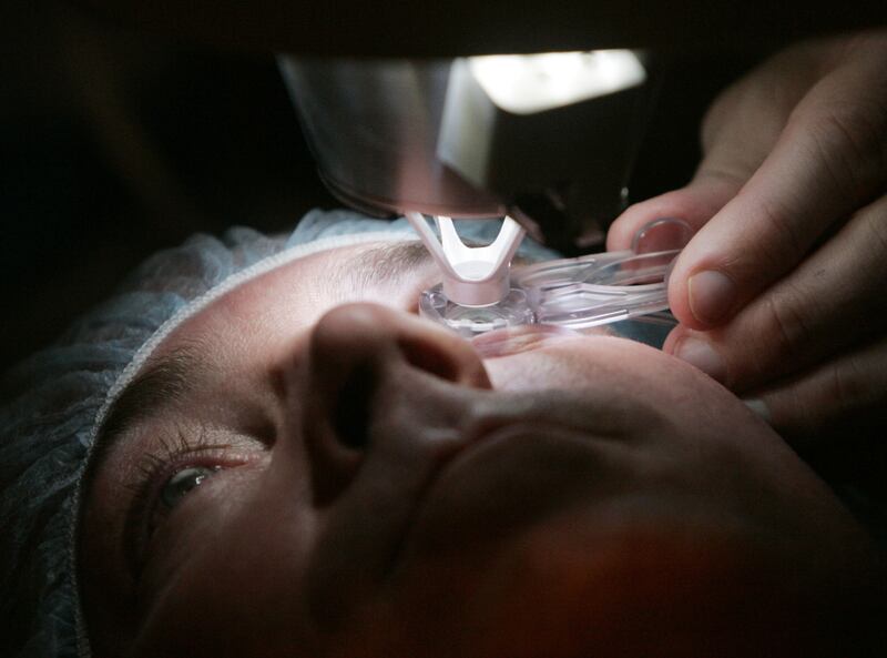 Dr. Colman Kraff docks the femtosecond laser, flattening the cornea, of patient Steve Parker during Parker’s eye surgery at Kraff’s offices in Chicago.