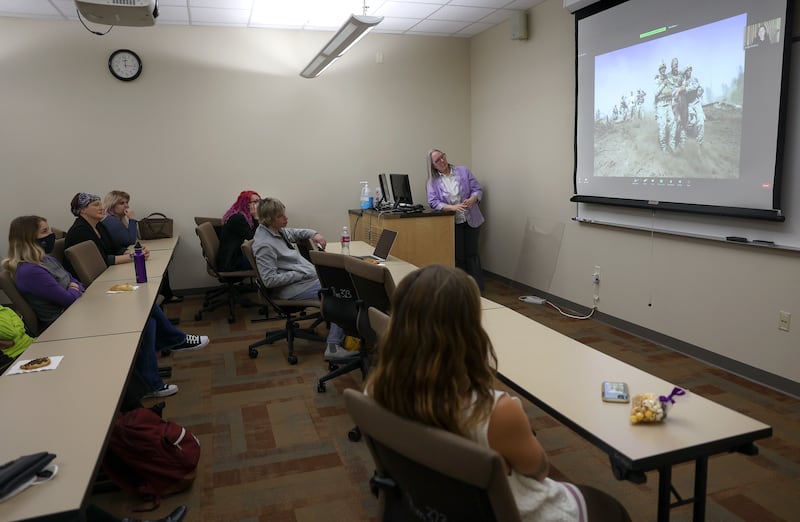 Weber State University students and staff listen and watch as photojournalist Lynsey Addario, who is currently covering the war in Ukraine for The New York Times, talks about her work during a video call at Elizabeth Hall in Ogden.