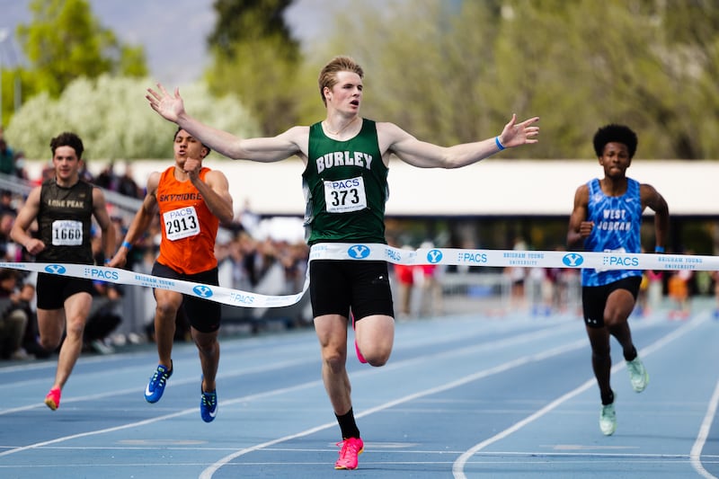 Burley High’s Gatlin Bair looks at the screen after winning the boys 100-meter race during the BYU Track Invitational.