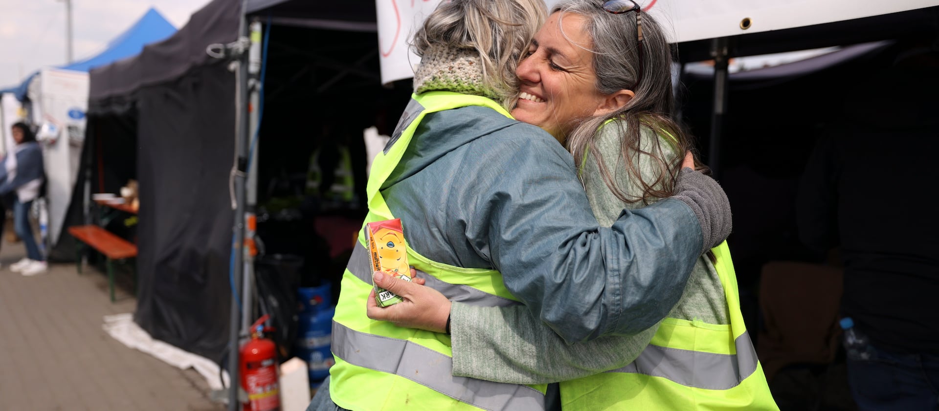 Louise Martin, left, hugs Jennifer De Tapia, of Salt Lake City, as they volunteer for the Siobhan’s Trust tent in Medyka, Poland.