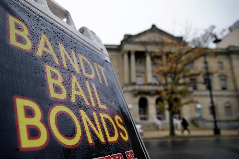A sign is seen outside a bail bondsman across the street from Mercer County criminal courthouse Thursday, Oct. 23, 2014, in Trenton, N.J. (AP Photo/Mel Evans)