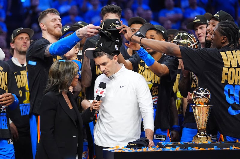 Oklahoma City Thunder players put hats on the head of head coach Mark Daigneault, center, as they celebrate winning the NBA championship with a Game 7 victory against the Indiana Pacers Sunday, June 22, 2025, in Oklahoma City.