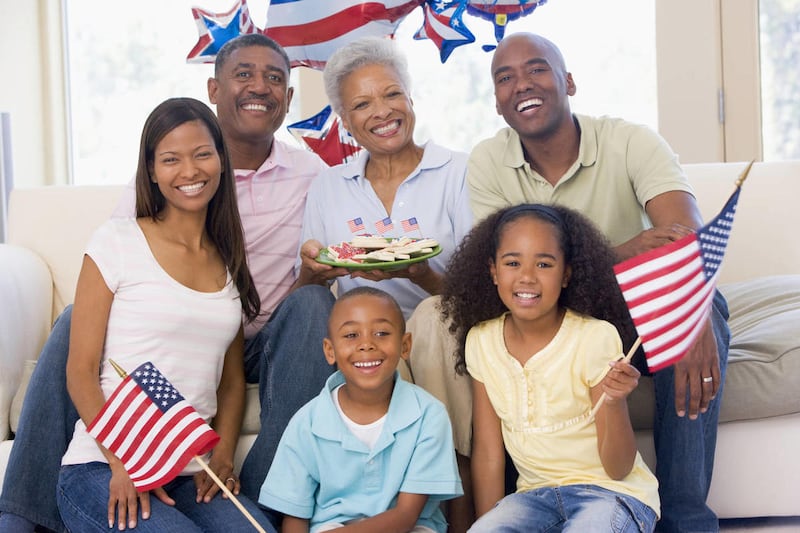 A family celebrates the Fourth of July in their living room. The holiday is a time to reflect on both patriotism and faith, in the right doses.