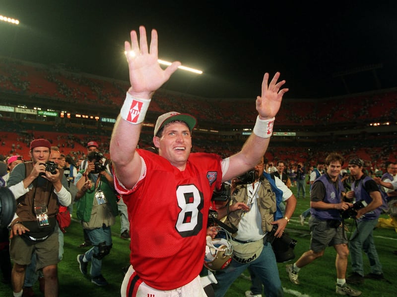 San Francisco 49ers quarterback Steve Young (8) runs a victory lap after his team beat the San Diego Chargers on Jan. 29, 1995, in Super Bowl XXIX.