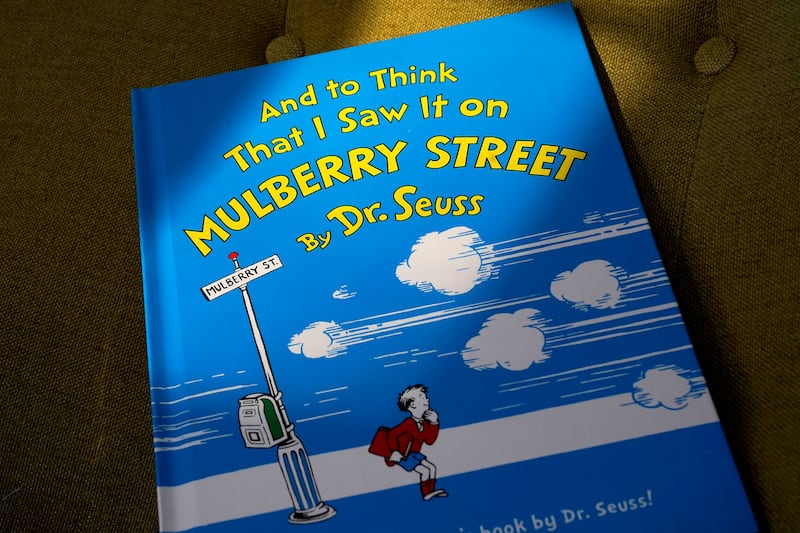A copy of the book “And to Think That I Saw It on Mulberry Street,” by Dr. Seuss, rests in a chair, Monday, March 1, 2021, in Walpole, Mass. Dr. Seuss Enterprises said that 6 books from Dr. Seuss will be canceled.