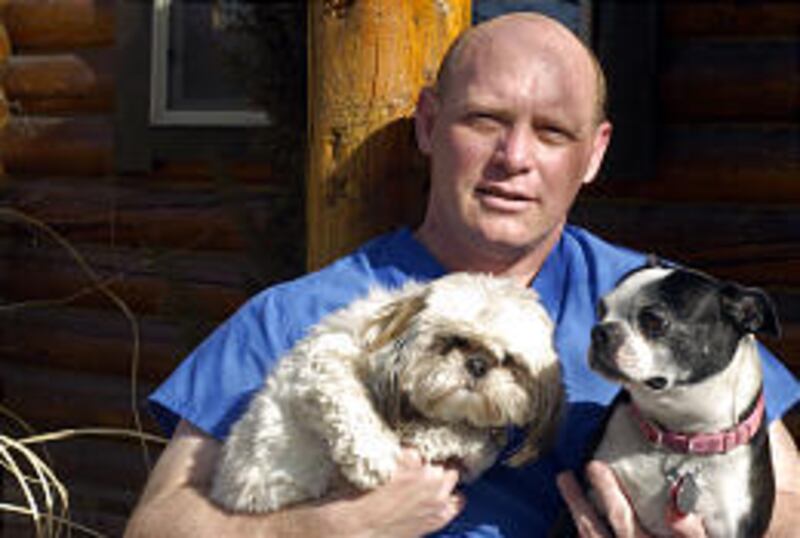 Dr. Alan Cunningham, with C.C., left, and Angel, has done counseling with owners who have lost pets. Besides books, he has a support group and hotline.