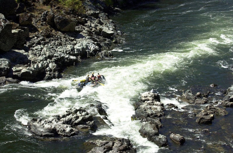 FILE - This Aug. 23, 2005 file photo shows a raft dropping through Grave Creek Falls on the wild section of the Rogue River in southwestern Oregon. The Oregon Department of Water Resources has denied a water permit for an Australian mining company that w