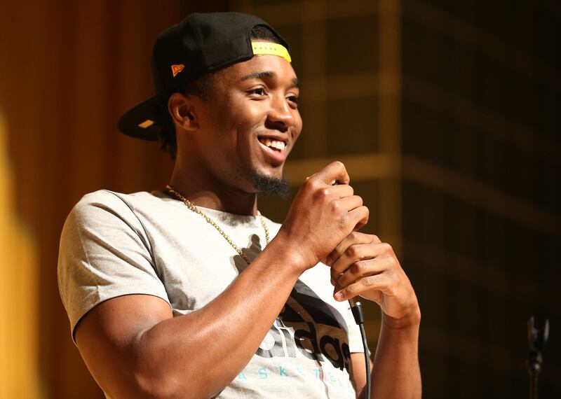 Utah Jazz player Donovan Mitchell talks with students and hands out backpacks at Kearns High in Kearns on Tuesday, Aug. 21, 2018.