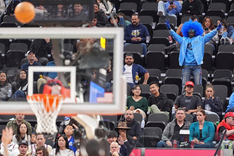 A fan cheers as a shot by Los Angeles Clippers guard Amir Coffey goes in during a game against the Utah Jazz, Sunday, Nov. 17, 2024, in Inglewood, Calif.