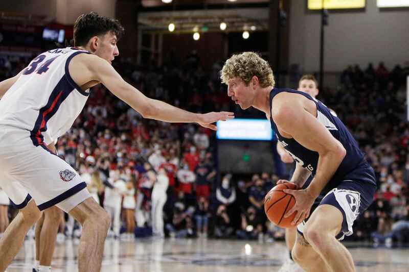 BYU forward Caleb Lohner, right, controls the ball while defended by Gonzaga center Chet Holmgren in Spokane, Wash.