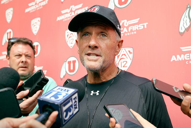 Utah coach Kyle Whittingham talks to members of the media outside of the Spence and Cleone Eccles Football Center.