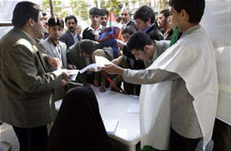 Iranians fill out registration papers indicating readiness to become suicide bombers.