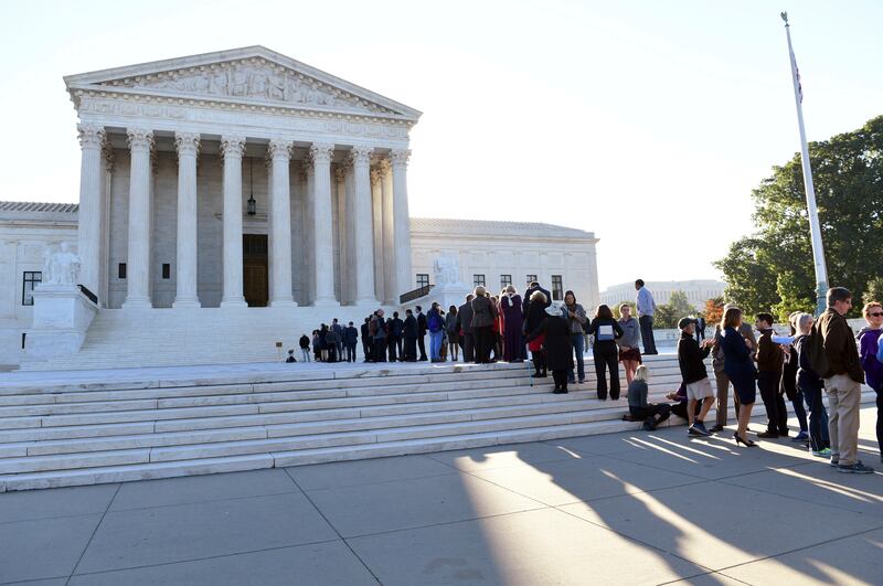 People stand in line to go into the Supreme Court in Washington, Monday, Oct. 2, 2017, for the first day of the new term. The Supreme Court term that, by law, begins on the first Monday in October includes several high-profile cases dealing with controver