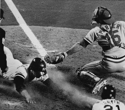 Catcher Darrell Porter of the St. Louis Cardinals reaches but can't make the tag in time on runner Jim Sundberg of the Kansas City Royals in the ninth inning of Game 6 of the World Series in Kansas City, Mo., Oct. 26, 1985. Sundberg scored on a pinch-hit