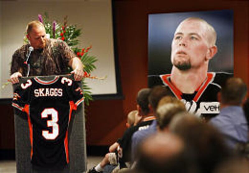 Blaze teammate Hans Olsen pauses for a moment as he relates stories about linebacker/receiver Justin Skaggs during a memorial service for the football player who died of brain cancer on Friday.