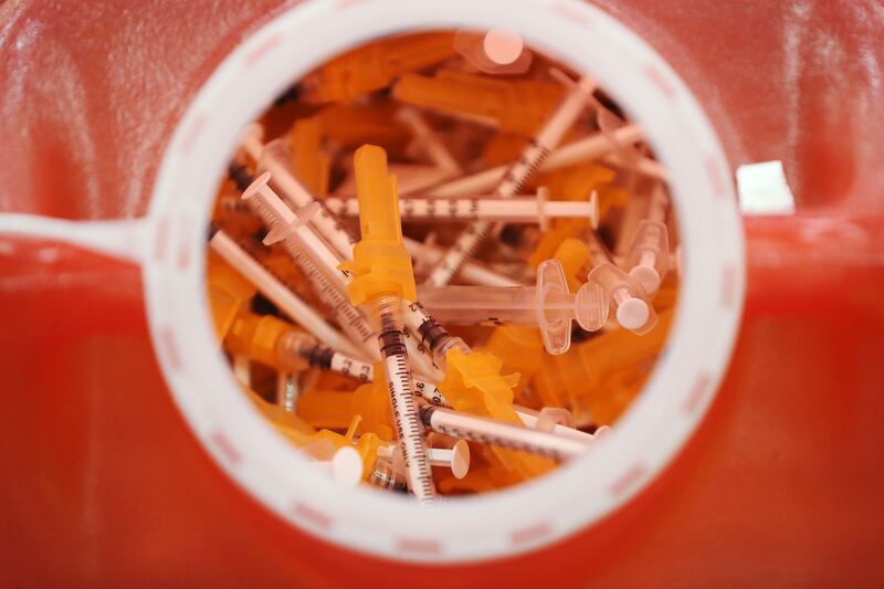 Used syringes are disposed of at a vaccination site.