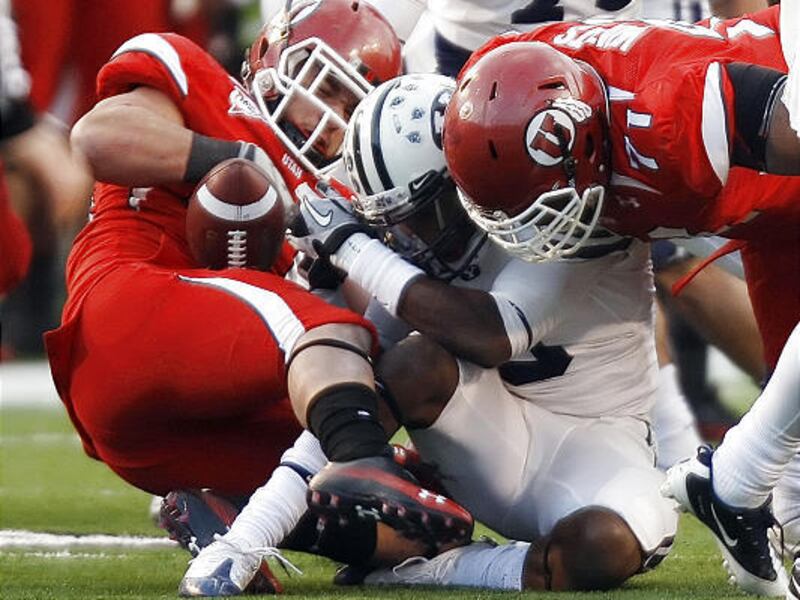 BYU's Brandon Bradley has the ball ripped away on a play that was ruled a fumble.